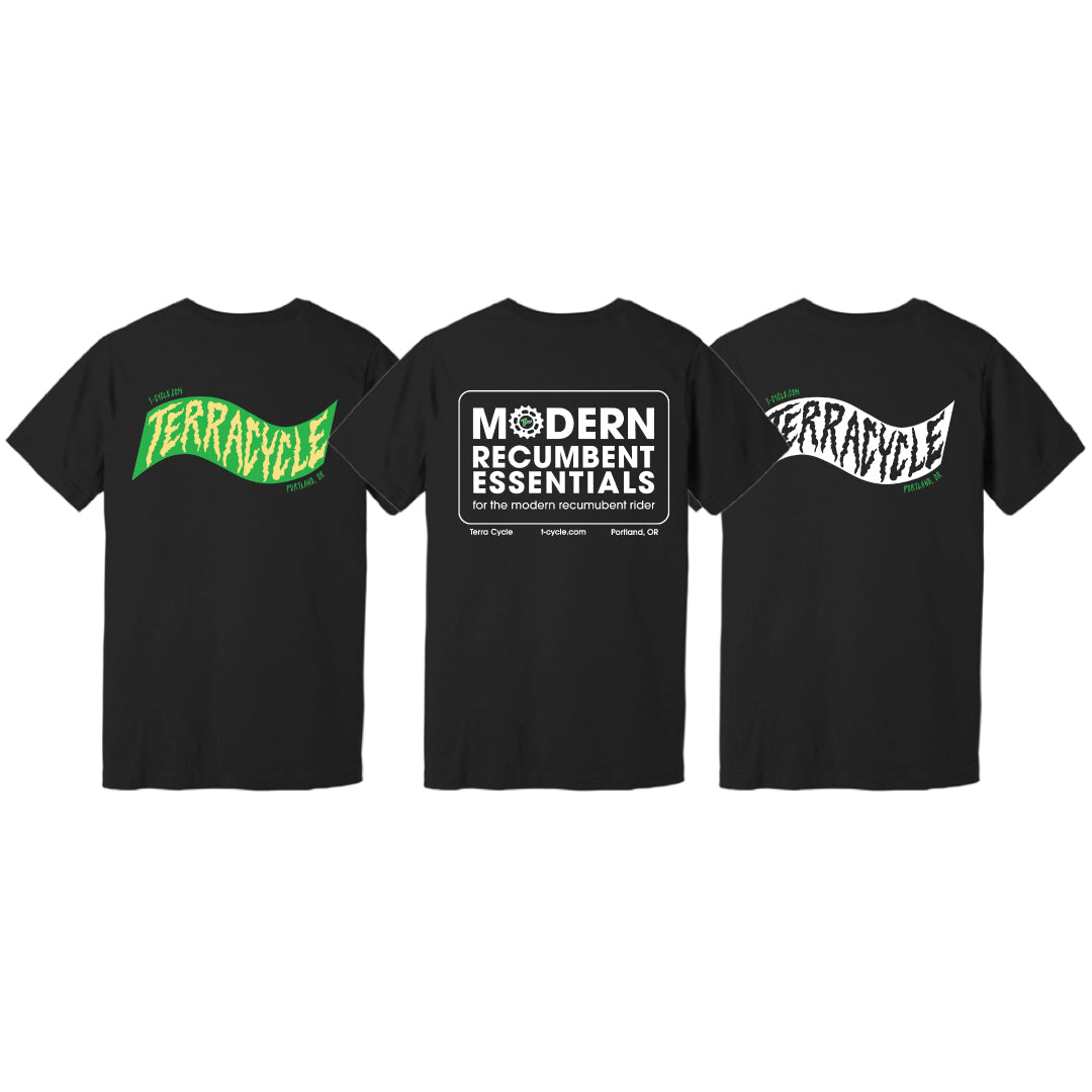Three black short-sleeve T-shirts shown against a white background, displaying the backs of three design options. The left shirt features a green and yellow wavy 'TERRACYCLE' graphic, the middle features a large rectangle with rounded corners with 'MODERN RECUMBENT ESSENTIALS for the modern recumbent rider' centered inside, and the right shows a white and black wavy 'TERRACYCLE' logo.